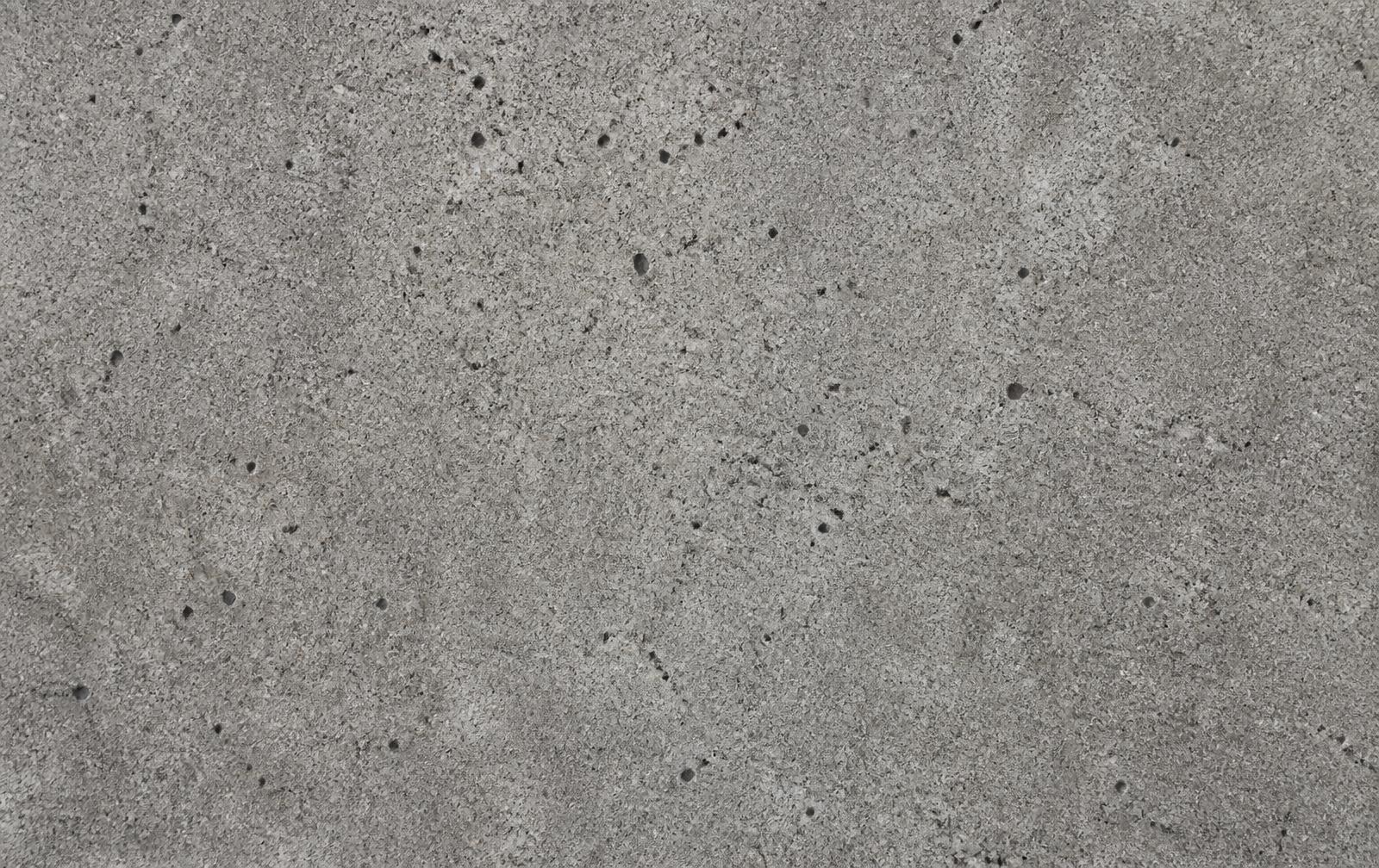 Macro view of water droplets beading on a concrete surface