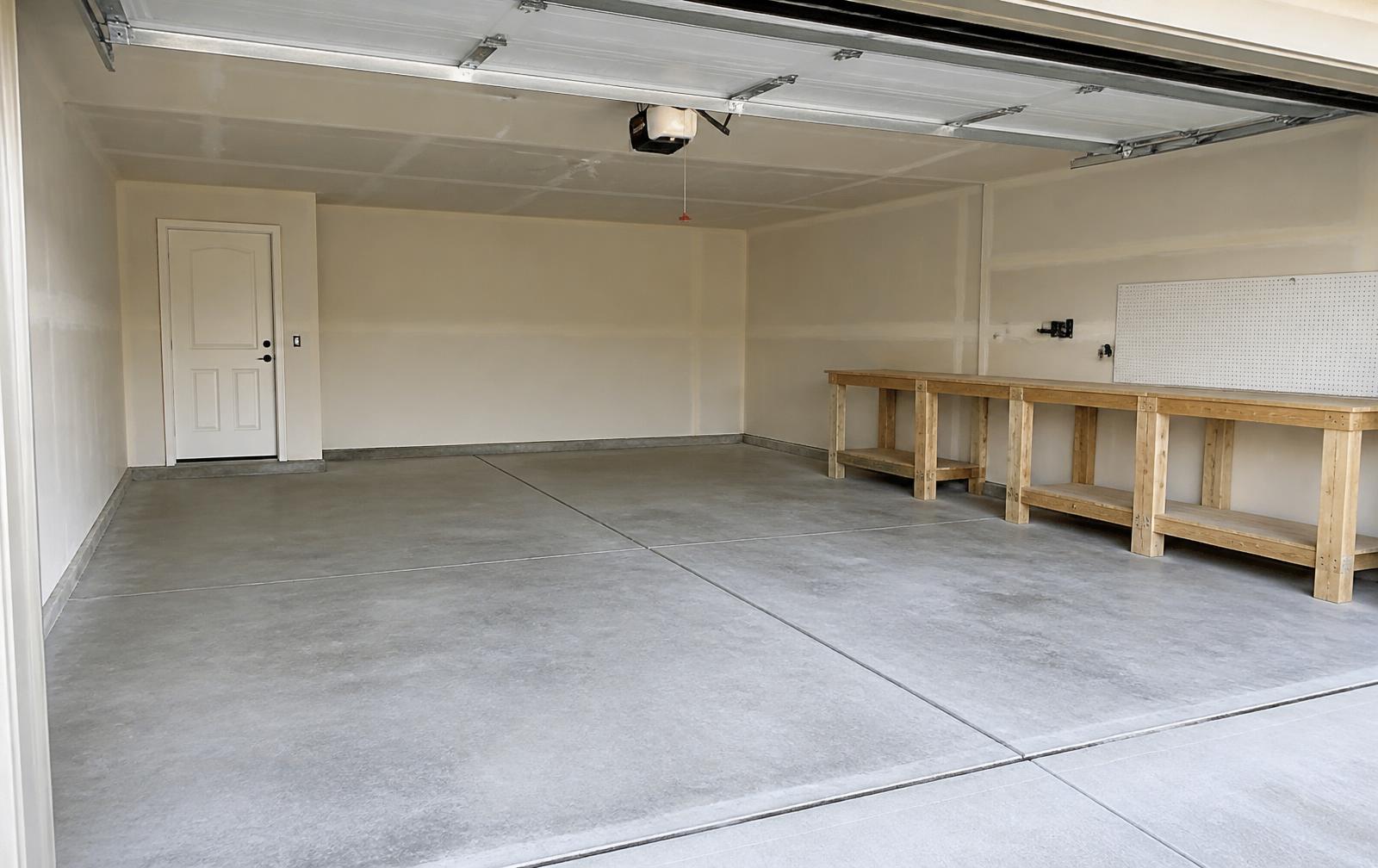 Empty two-car garage with bare gray concrete floor